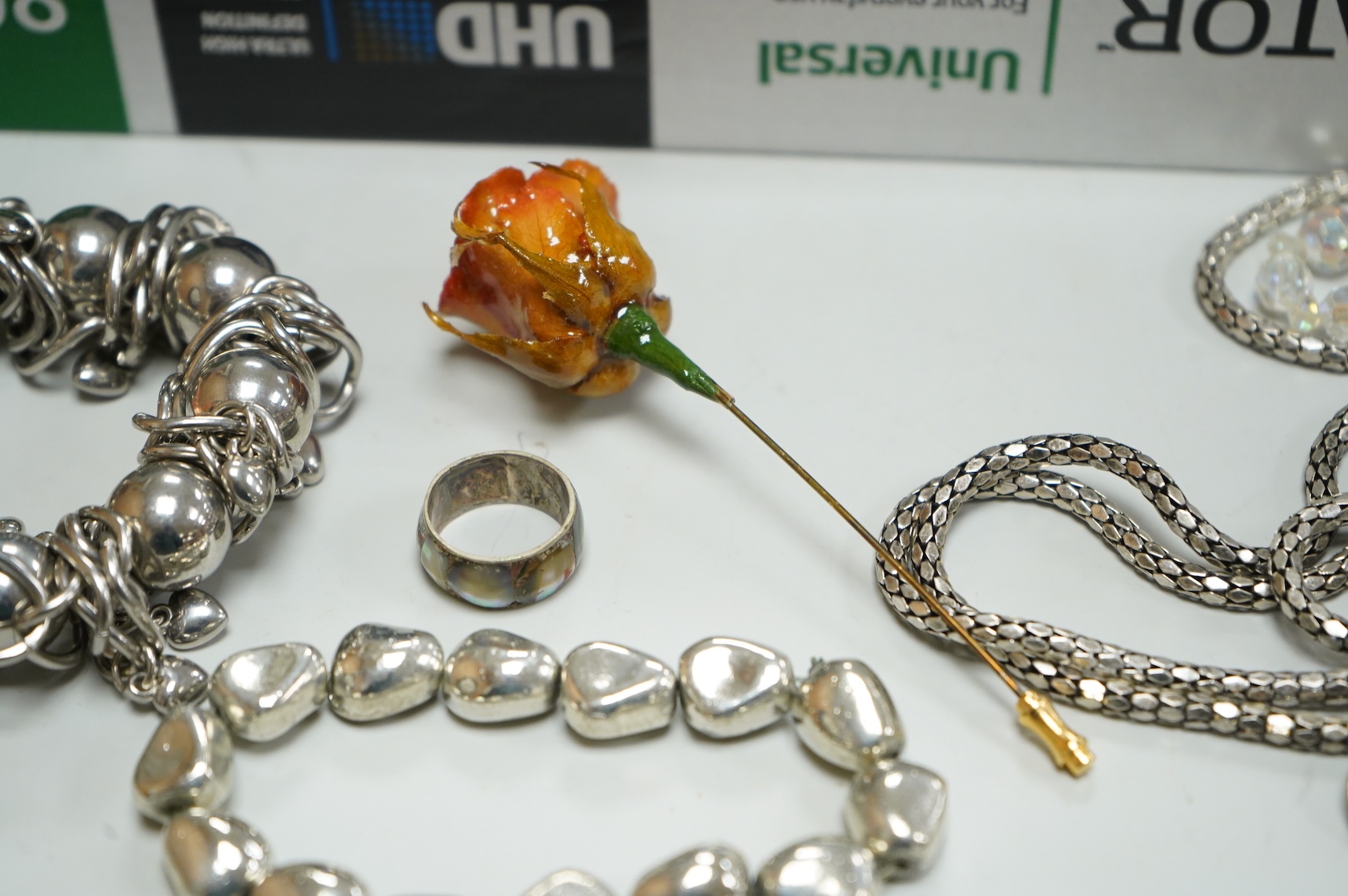 A collection of assorted costume jewellery, including a pair of spherical amethyst drop earrings, a modern silver mounted aide memoire, brooches, necklaces, rings et.